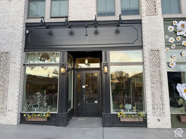 Brick exterior with decorative accents, large display windows, and a central entry door