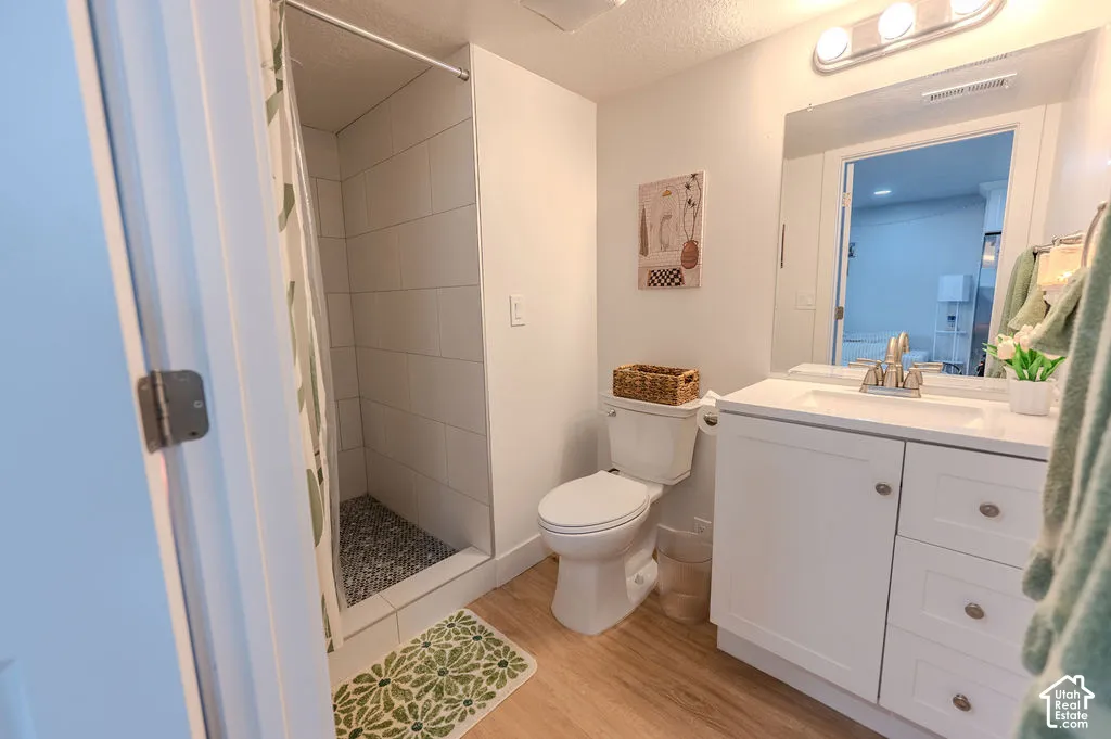 Walk-in shower with tiled walls and pebble flooring