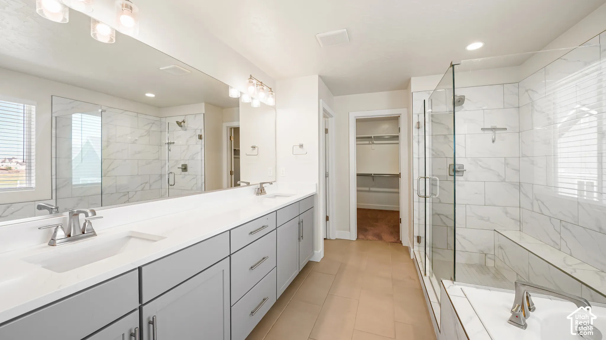 Dual vanity with undermount sinks and light gray cabinetry