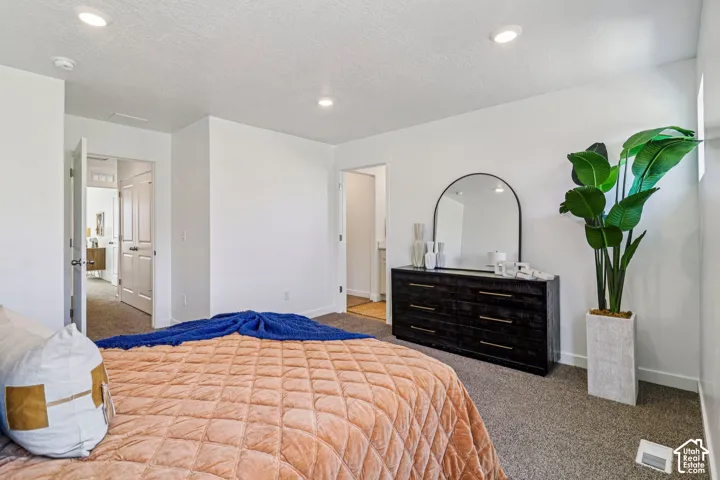 White walls, recessed lighting, and soft carpet flooring