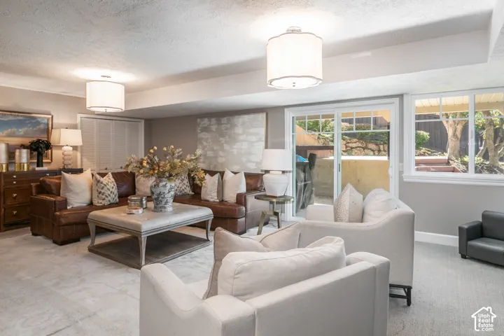 Recessed lighting throughout, sliding glass door with transom windows, white window trim, and a built-in storage closet