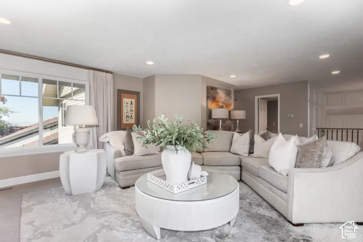 Spacious living area featuring neutral wall tones and recessed lighting