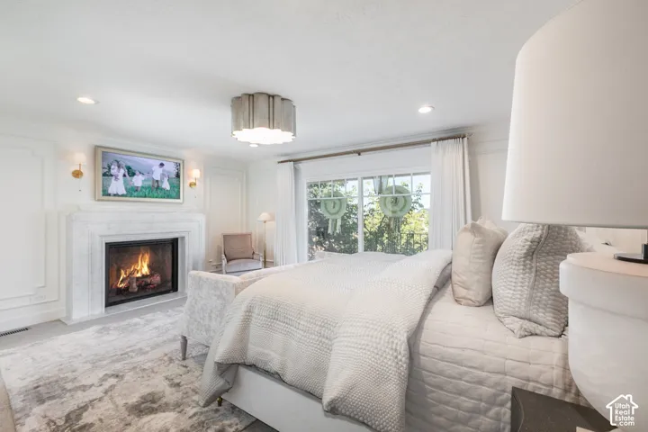 Stone fireplace with a dark firebox, wall paneling, and an integrated wall-mounted screen