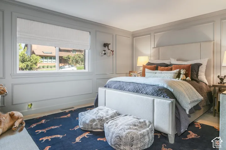 Room featuring paneled wall detailing and crown molding