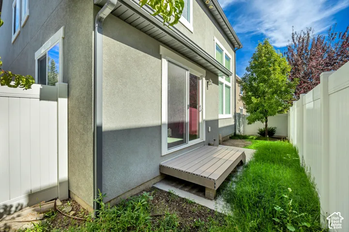 Stucco exterior with white trim windows and a sliding glass door