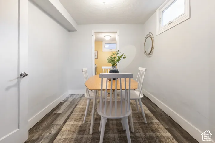 Recessed lighting, wood-finish flooring, white trim throughout, and a high window