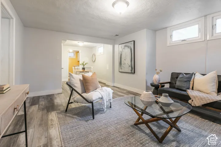 Recessed lighting, wood-finish flooring, and white trim