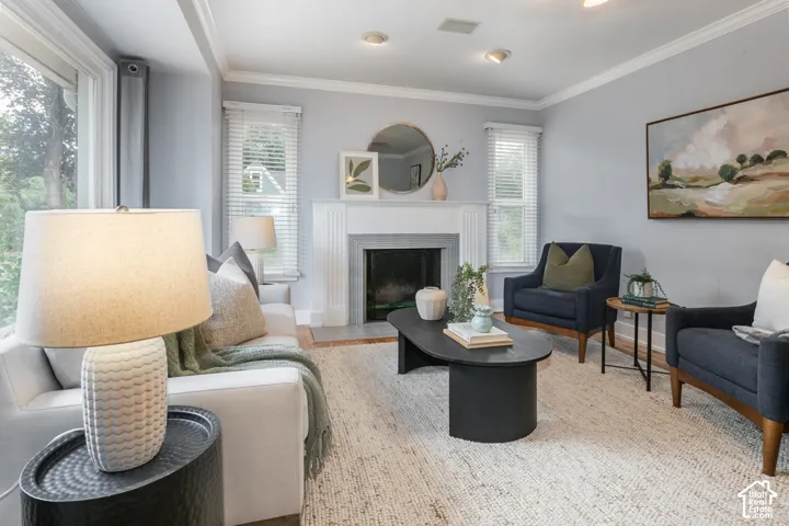 Recessed lighting, crown molding, and a fireplace with a traditional mantel