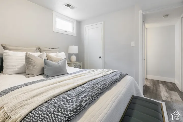 Light gray walls, a high transom window, wood-finish flooring, and white trim