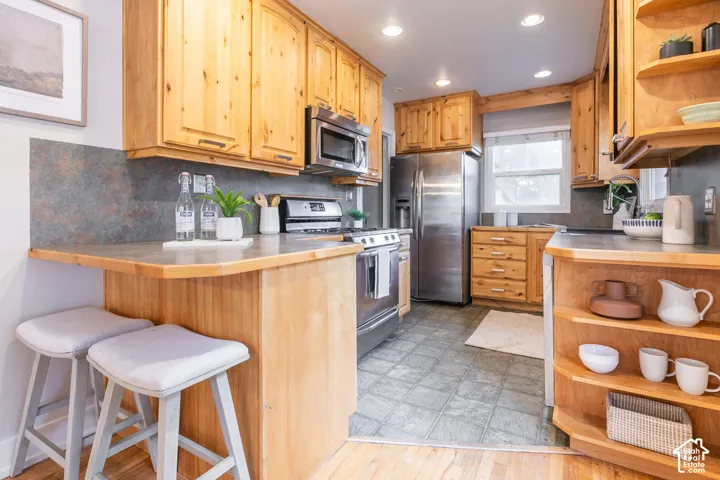 Wood cabinetry and built-in shelving complement stainless steel appliances