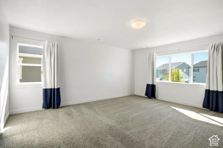 Recessed lighting, large window with expansive views, secondary window, and plush carpet flooring