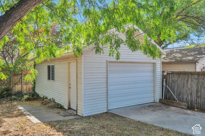 Detached oversized one car garage with opener and a side entry door