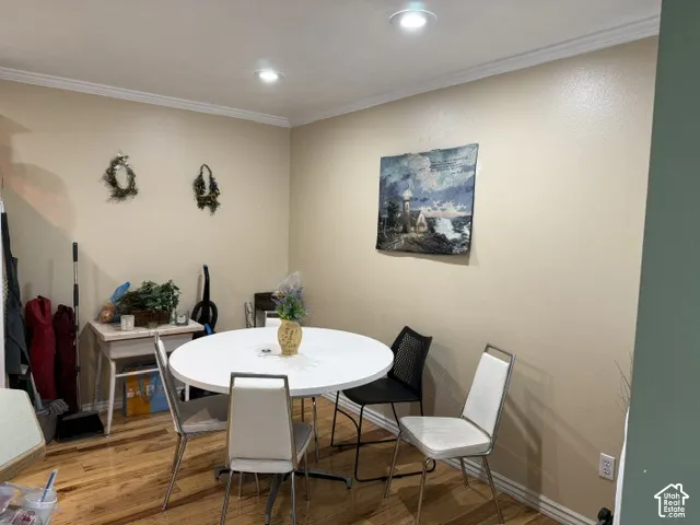 Wood-finish flooring with crown molding and recessed lighting