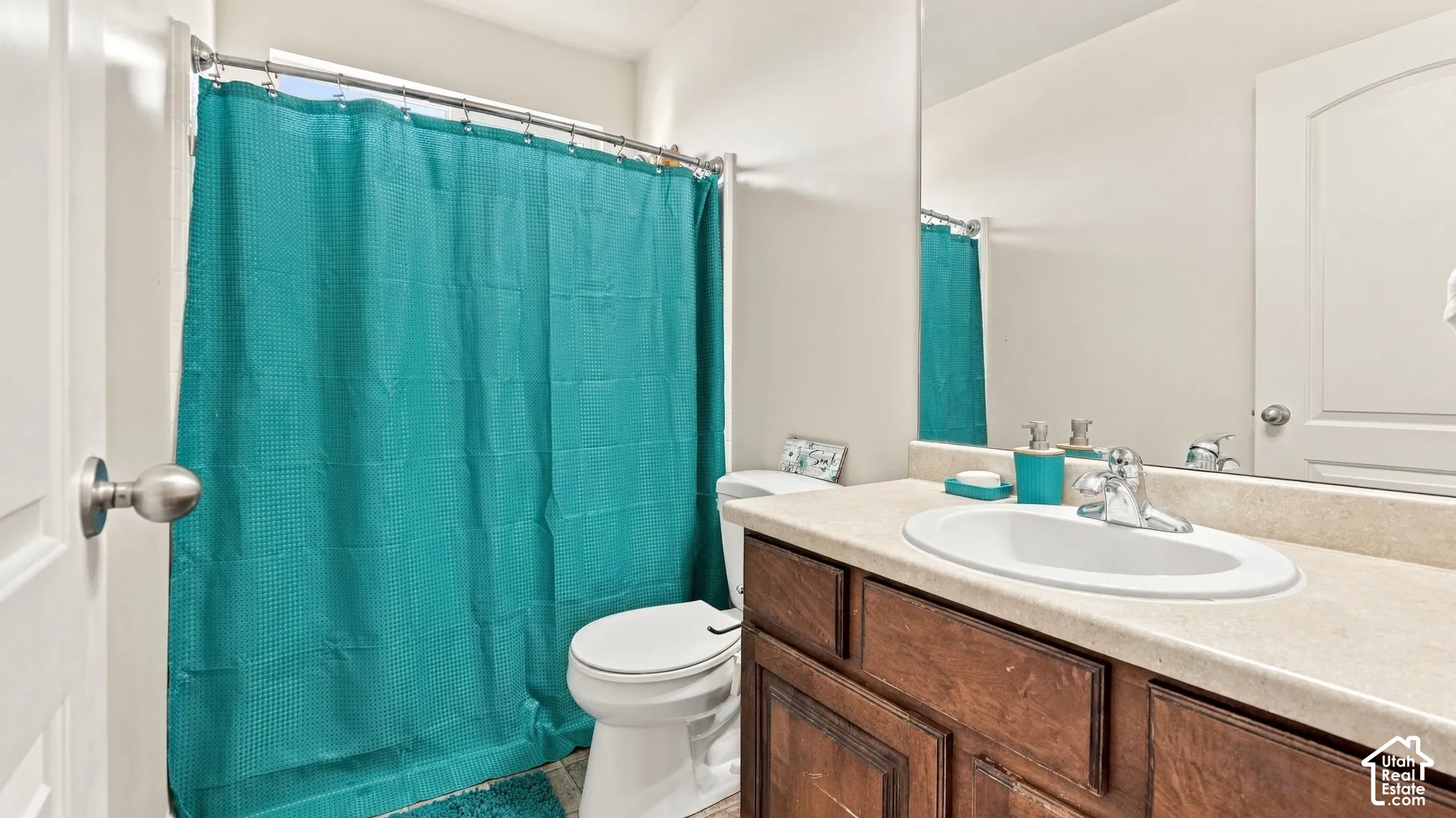 Vanity with a built-in sink, chrome faucet, and wood-finish cabinetry