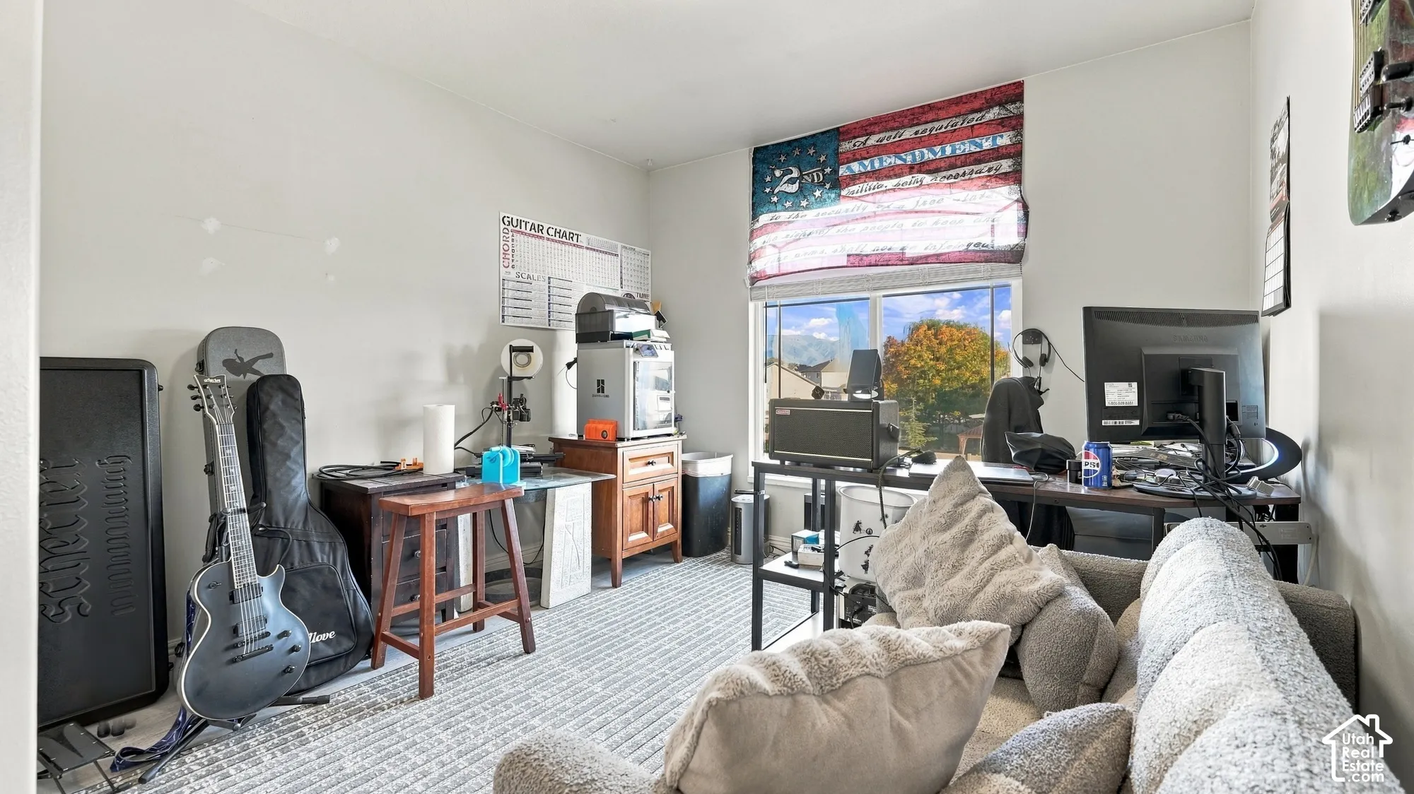 Window with a decorative Roman shade, light-toned walls, and neutral-toned carpeting