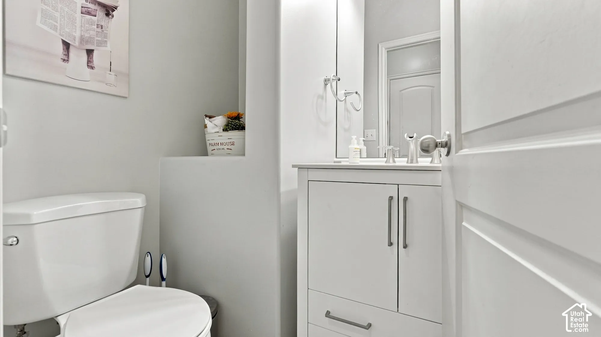 White vanity with integrated sink, polished chrome faucet, and coordinating hardware