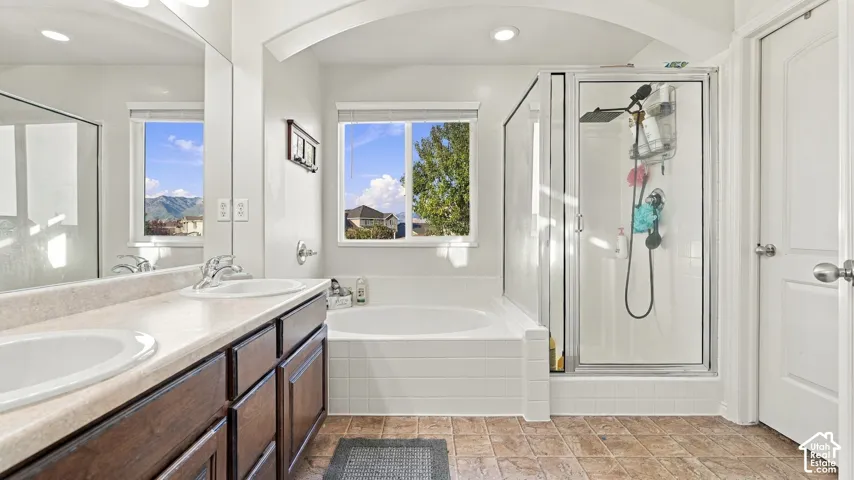 Dual vanity with undermount sinks and wood-finish cabinetry