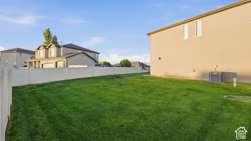 Expansive green lawn with vinyl fencing