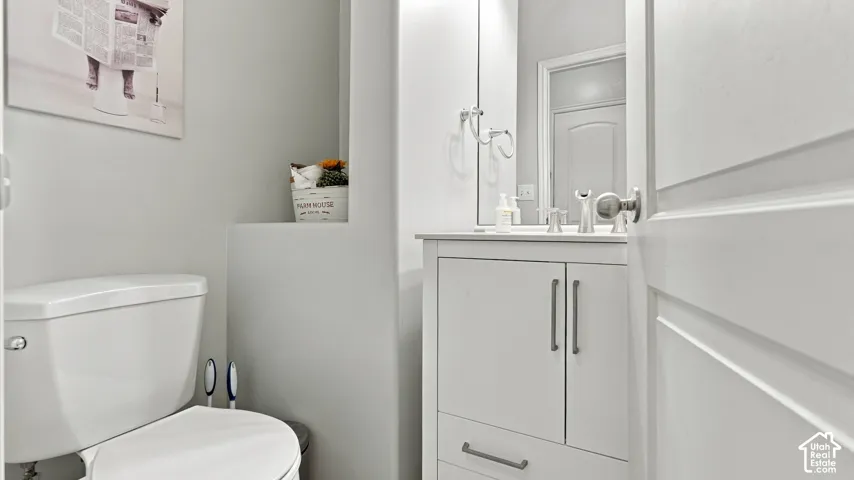 White vanity with integrated sink, polished chrome faucet, and coordinating hardware