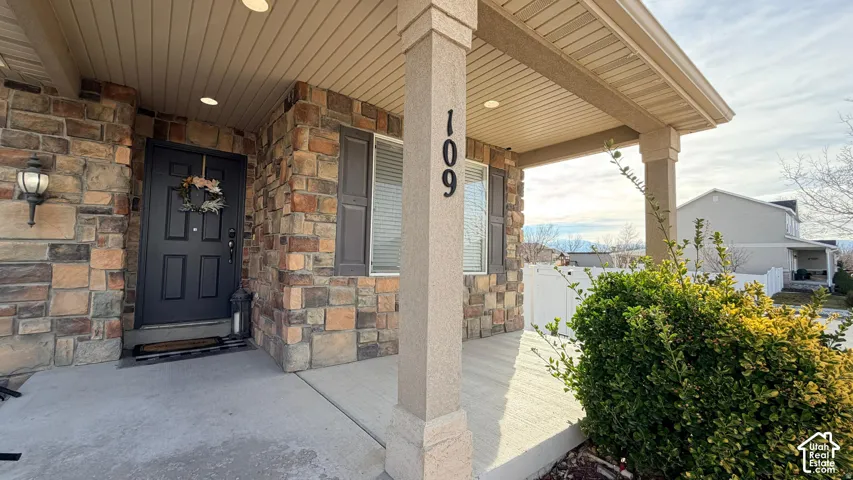 Stone veneer facade with a covered entry