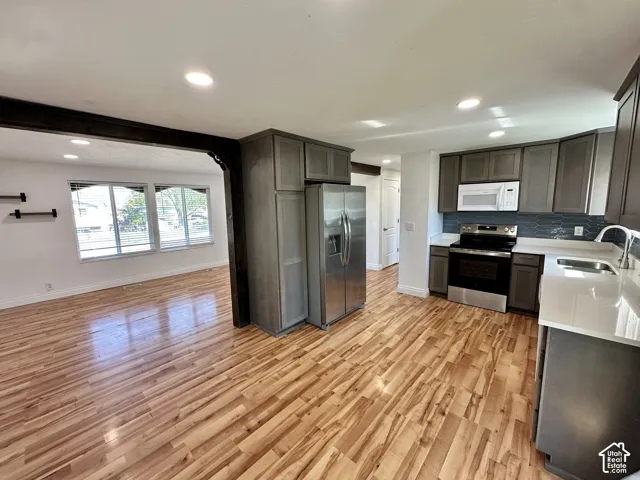 Kitchen with wood-finish flooring, recessed lighting, and gray cabinetry