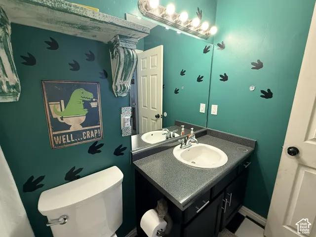 Vanity with an integrated sink, polished chrome faucet, and dark-finish cabinet storage