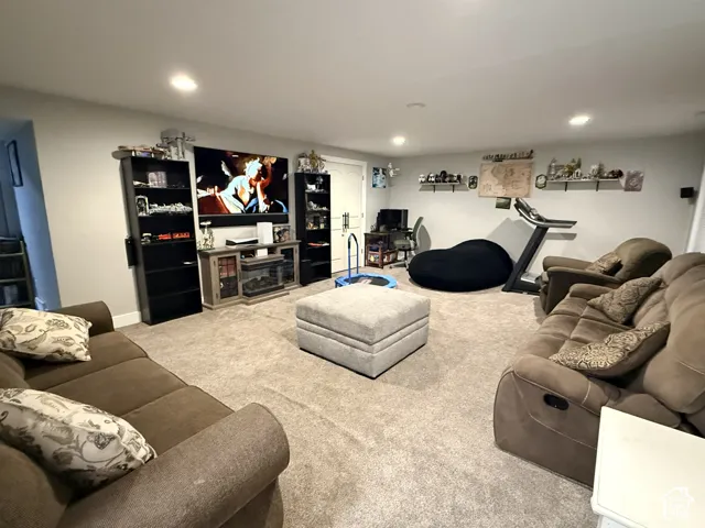 Recessed ceiling lighting, wall-mounted shelving, and carpeted flooring