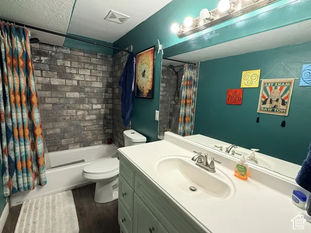 Bathroom featuring a white vanity with integrated sink, a single-handle faucet, and an overhead vanity light bar