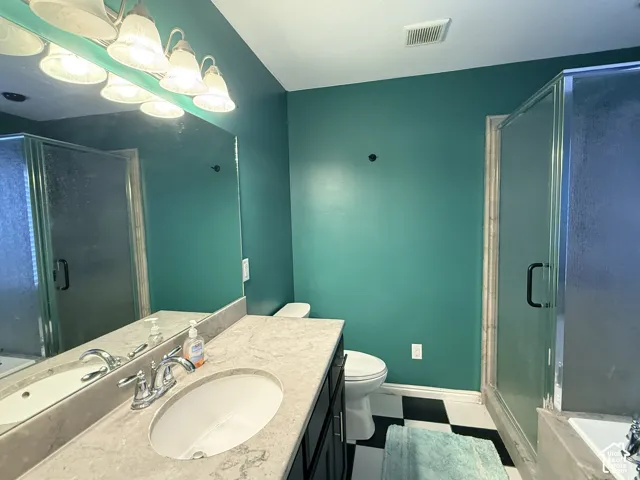 Vanity with a polished chrome faucet, under-mount sink, and light-toned countertop