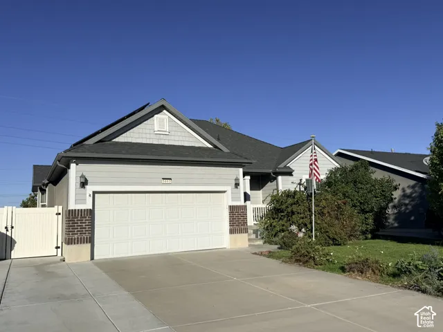 Light gray siding exterior with a dark gray shingle roof