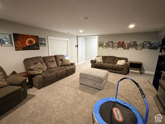 Recessed lighting, light gray walls, window with blinds, and carpeted flooring
