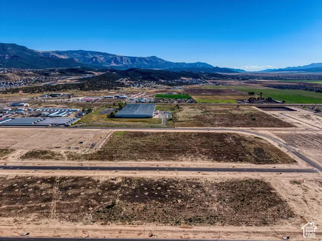 Expansive undeveloped land featuring graded roadways and distant mountain terrain