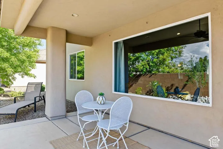Covered patio featuring recessed lighting, a large fixed window, and a secondary window