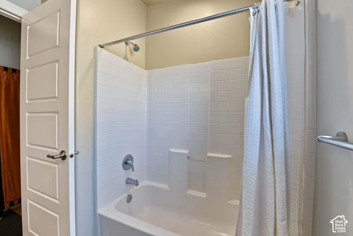 Tub and shower combination with white tile surround