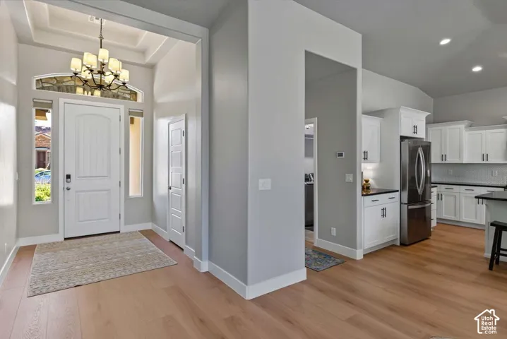 Recessed entryway with a coffered ceiling and decorative light fixture