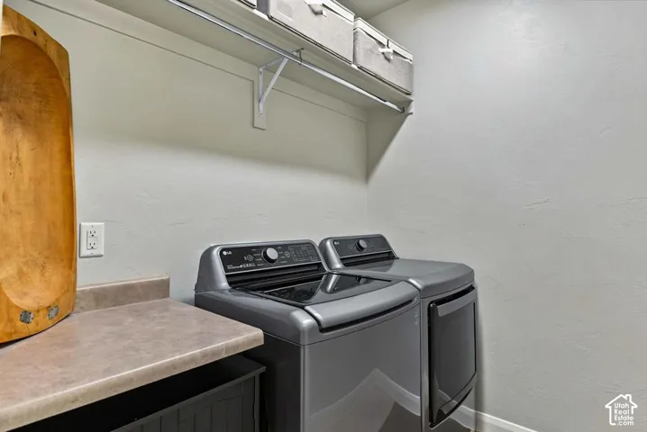 Built-in shelving with hanging rod, countertop space, and wall outlet