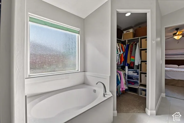 Soaking tub with a frosted window and chrome faucet