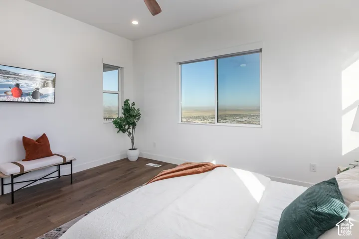 Expansive window, recessed ceiling lighting, wood-finish flooring, and a ceiling fan