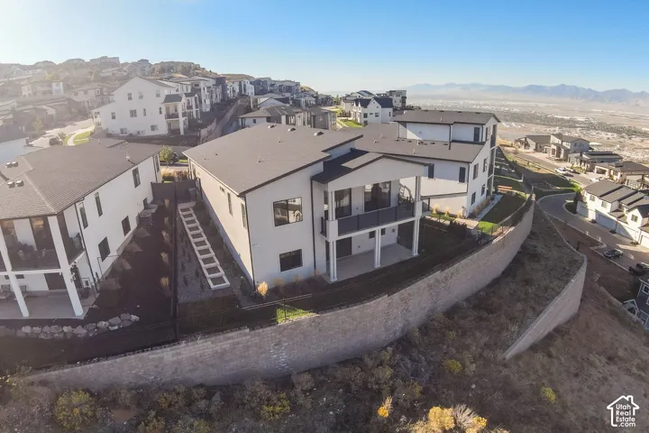 Modern multi-story property featuring roof and white exterior