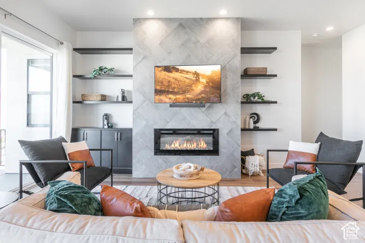 Modern linear gas fireplace with a chevron-patterned tile surround