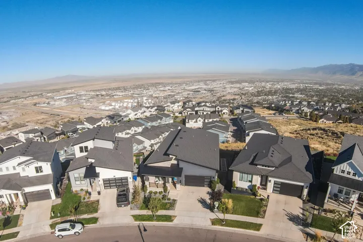Elevated hilltop community featuring contemporary homes with dark architectural rooflines, multi-car driveways, and manicured landscaping