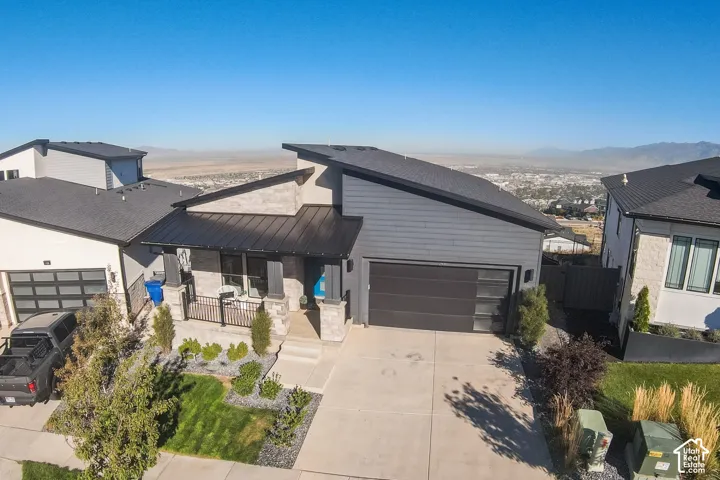 Aerial View - Contemporary exterior featuring a black metal roof and dark siding