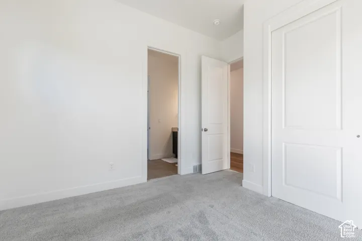 Light gray carpeting with white baseboards and trim