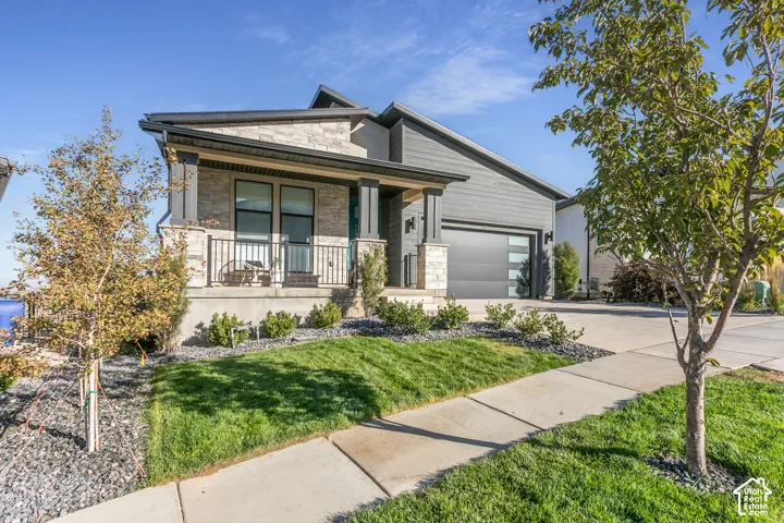 Stone and horizontal siding exterior, beautiful landscaping.