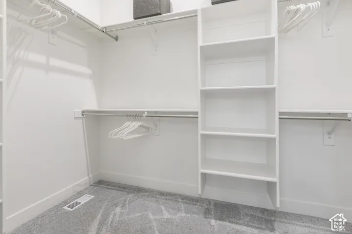 Integrated closet system featuring white shelving and hanging rods