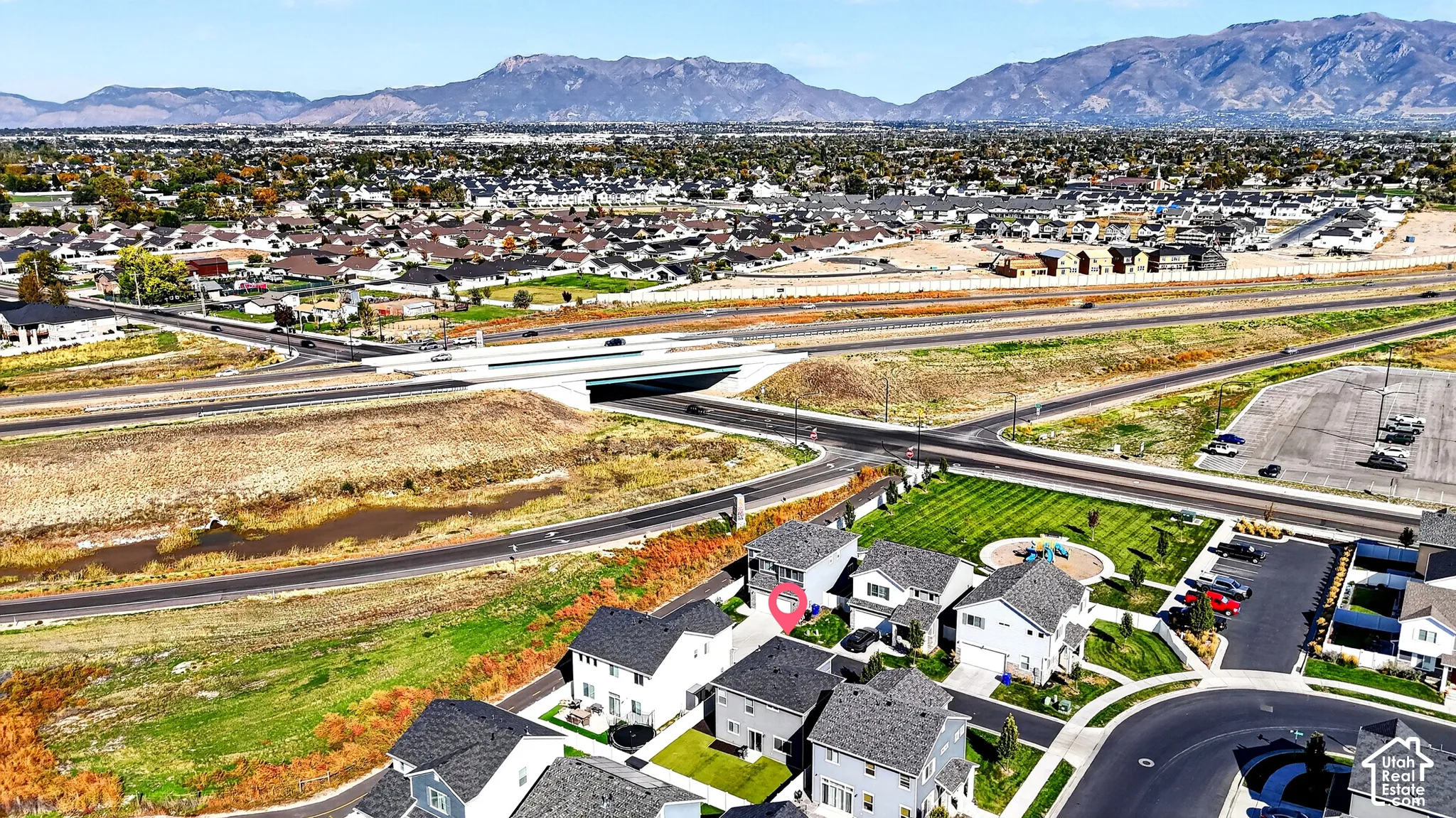 Residential neighborhood with mountainous backdrop, community green space, and infrastructure