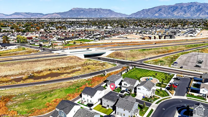 Residential neighborhood with mountainous backdrop, community green space, and infrastructure