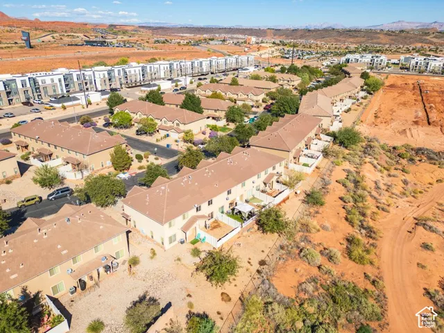 Expansive multi-unit community featuring neutral-toned exteriors, mature landscaping, and individual outdoor spaces