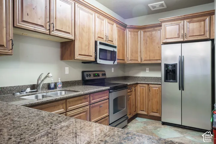 Wood-finish cabinetry paired with speckled countertops