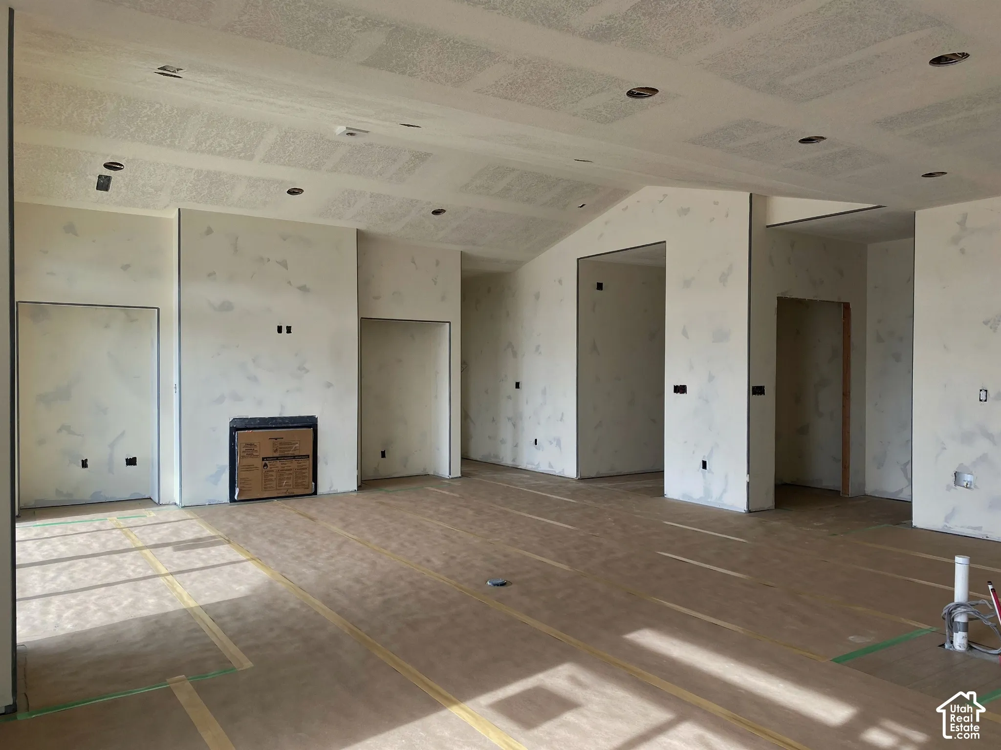 Vaulted ceiling with recessed lighting and a built-in fireplace